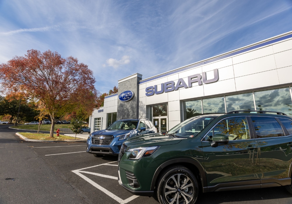 Two Subaru SUVs parked outside a Subaru dealership in Charlottesville, Virginia