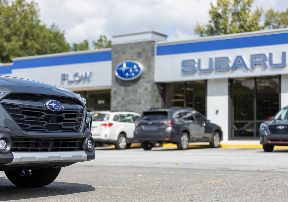 Subaru cars for sale parked in the dealership lot of Flow Subaru in Winston-Salem, NC