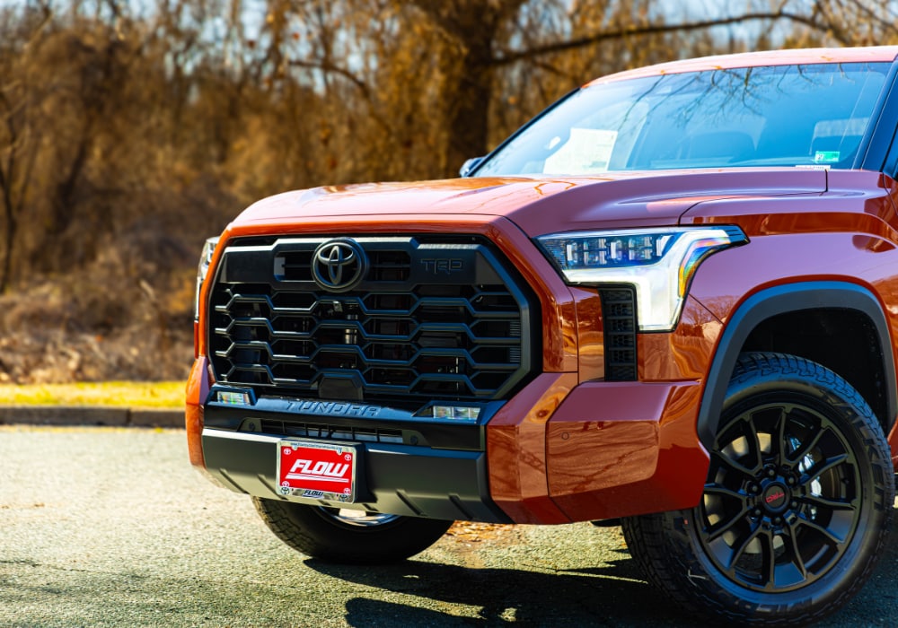 New Toyota Tundra truck for sale with a Flow license attached to the front grilled