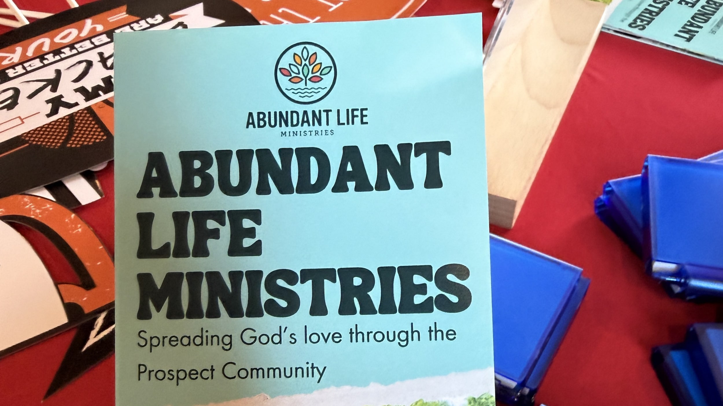 abundant life brochure being held over a table