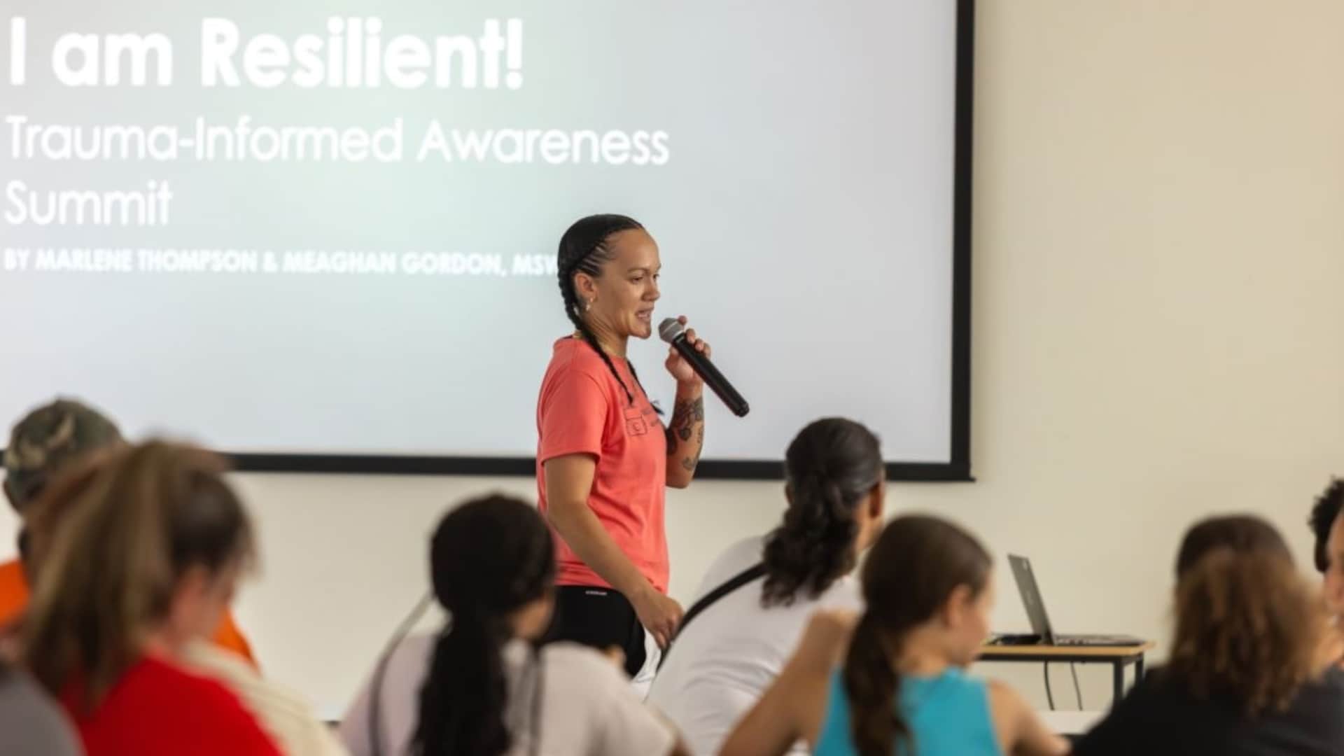 a photo of a woman speaking to a group of people