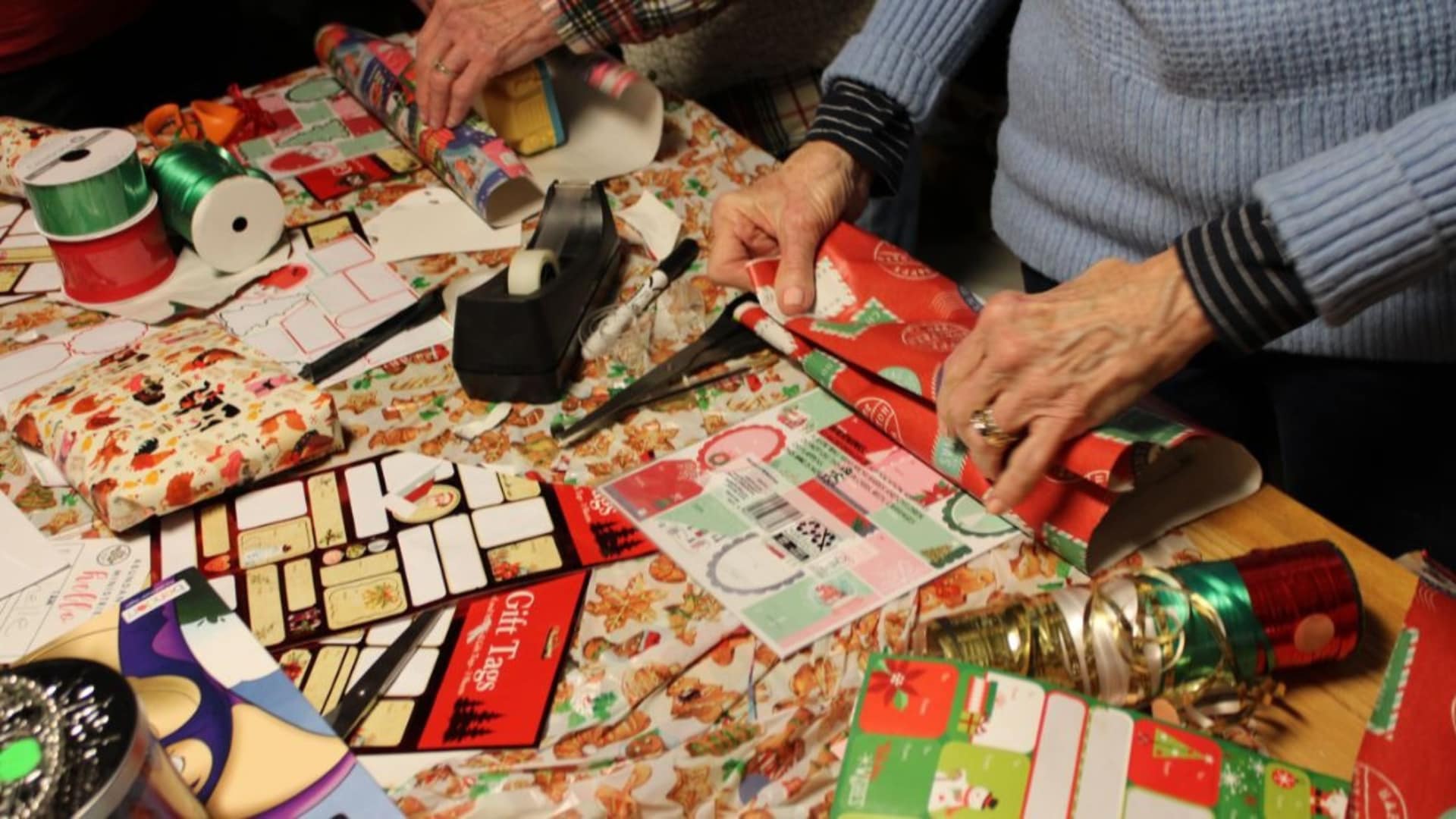 a photo of volunteers wrapping Christmas gifts