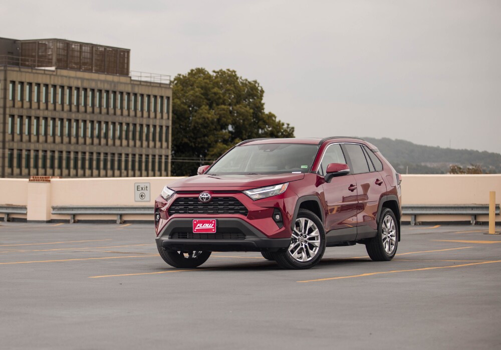 Toyota SUV parked on the roof of a parking deck. The SUV is red