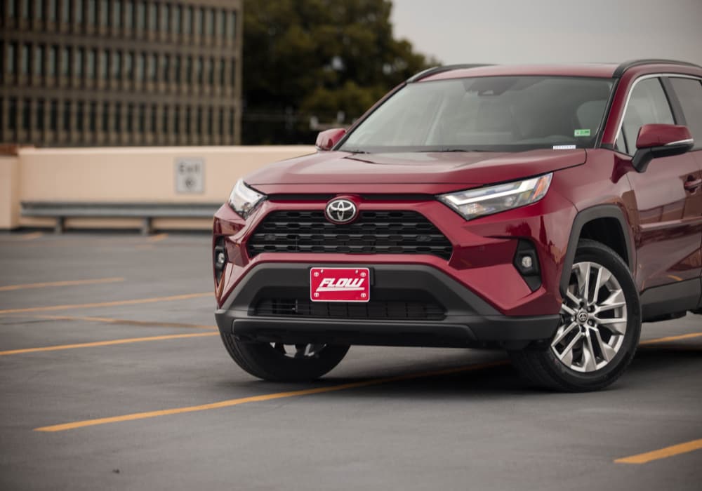 Red Toyota RAV4 parked in an empty area