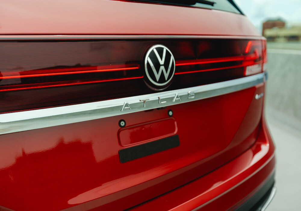 Close up photo of the back of a 2025 Volkswagen Atlas. The SUV is red