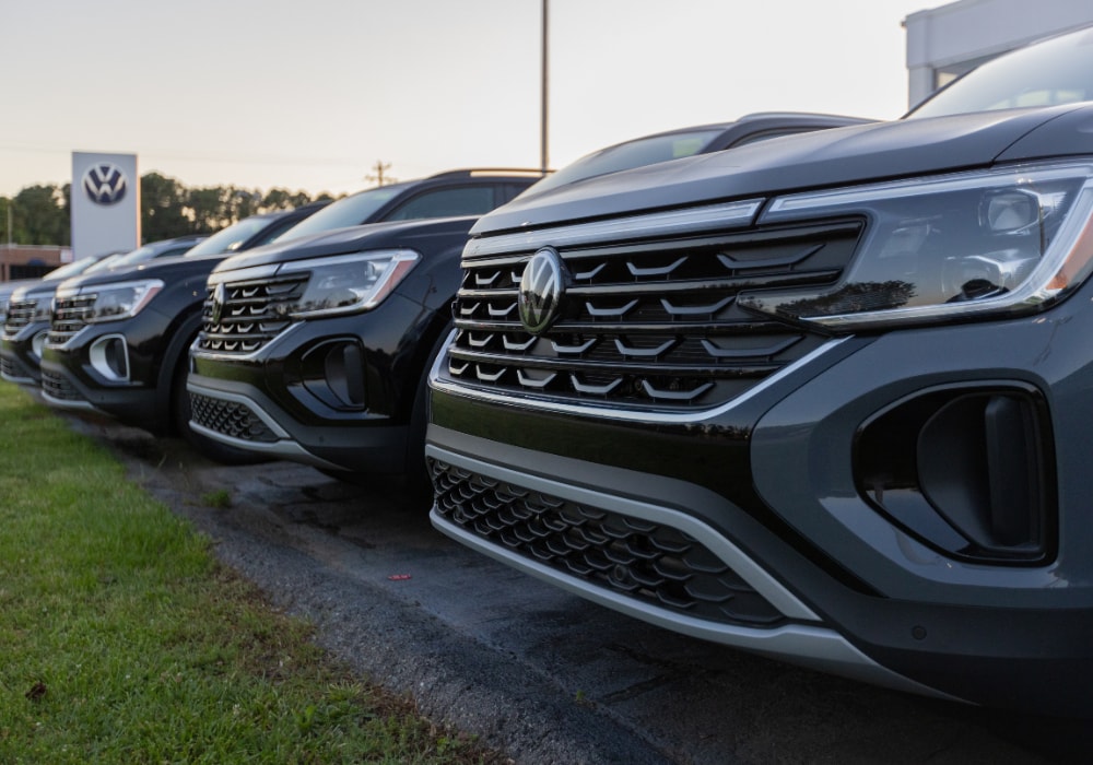 Lineup of Volkswagen SUVs parked outside the Flow Volkswagen of Durham dealership