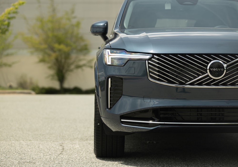 Close up photo of the front of a dark gray Volvo SUV