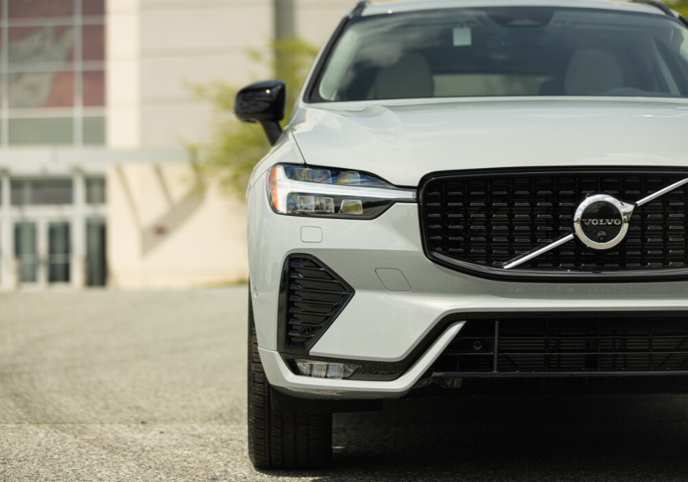 Close up photo of the front of a new Volvo XC60 SUV. The car is gray