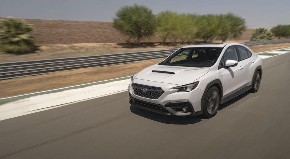 A 2022 Subaru WRX is shown driving on a racetrack.