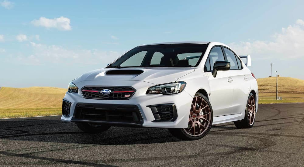 A white 2020 Subaru WRX STI Series.White is shown from the front parked in an empty lot.