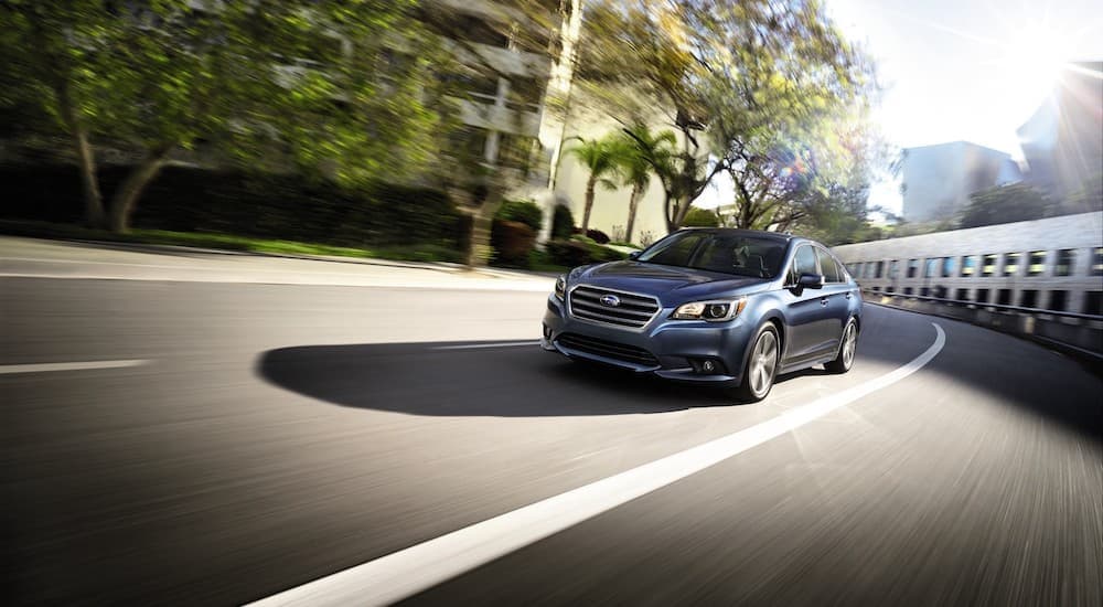 Certified Pre-Owned Subaru Legacy - 2017 Subaru Legacy Sport - Blue.jpg A blue 2017 Subaru Legacy Sport is shown driving on a city street.