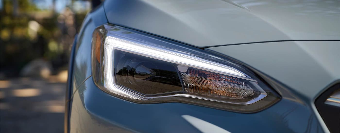 A close up shows the passenger headlight on a grey 2022 Subaru Crosstrek.