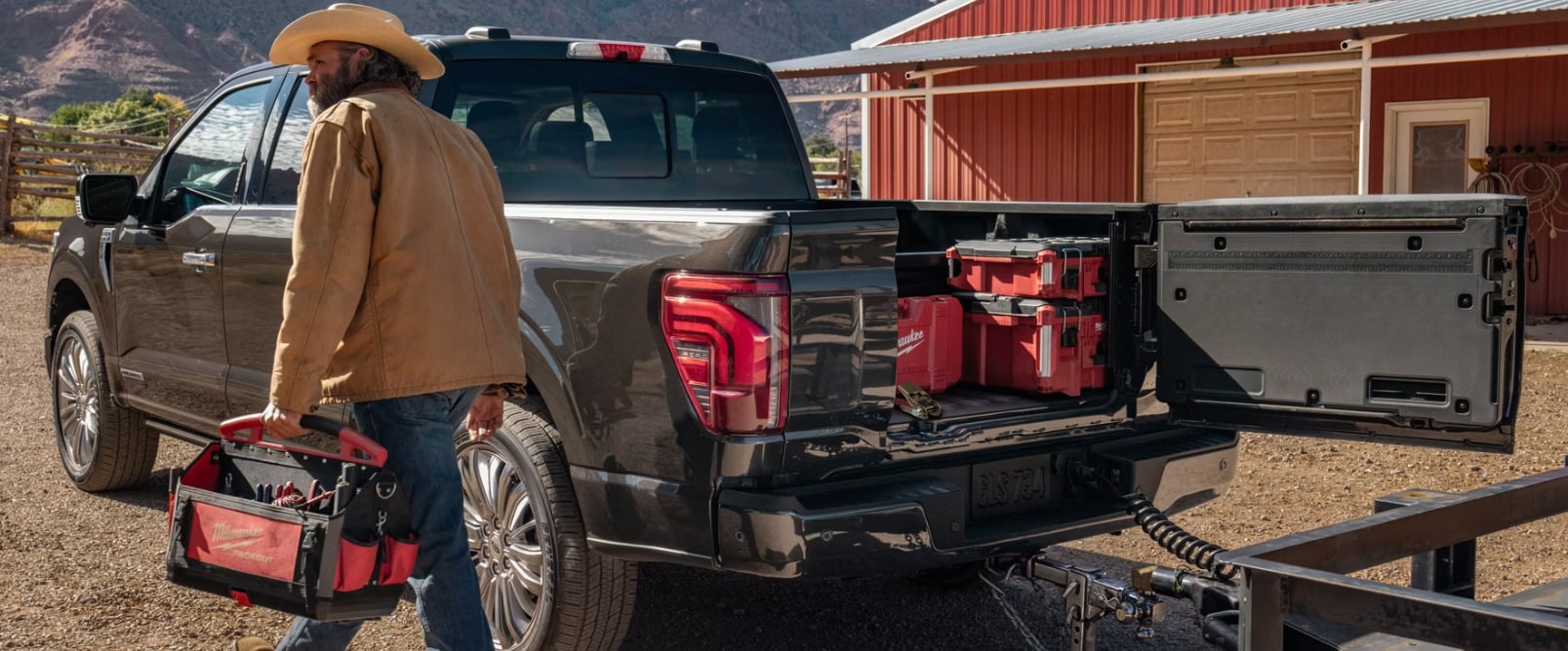 man next to 2026 Ford F‑150 with back door of truck bed open like a car door