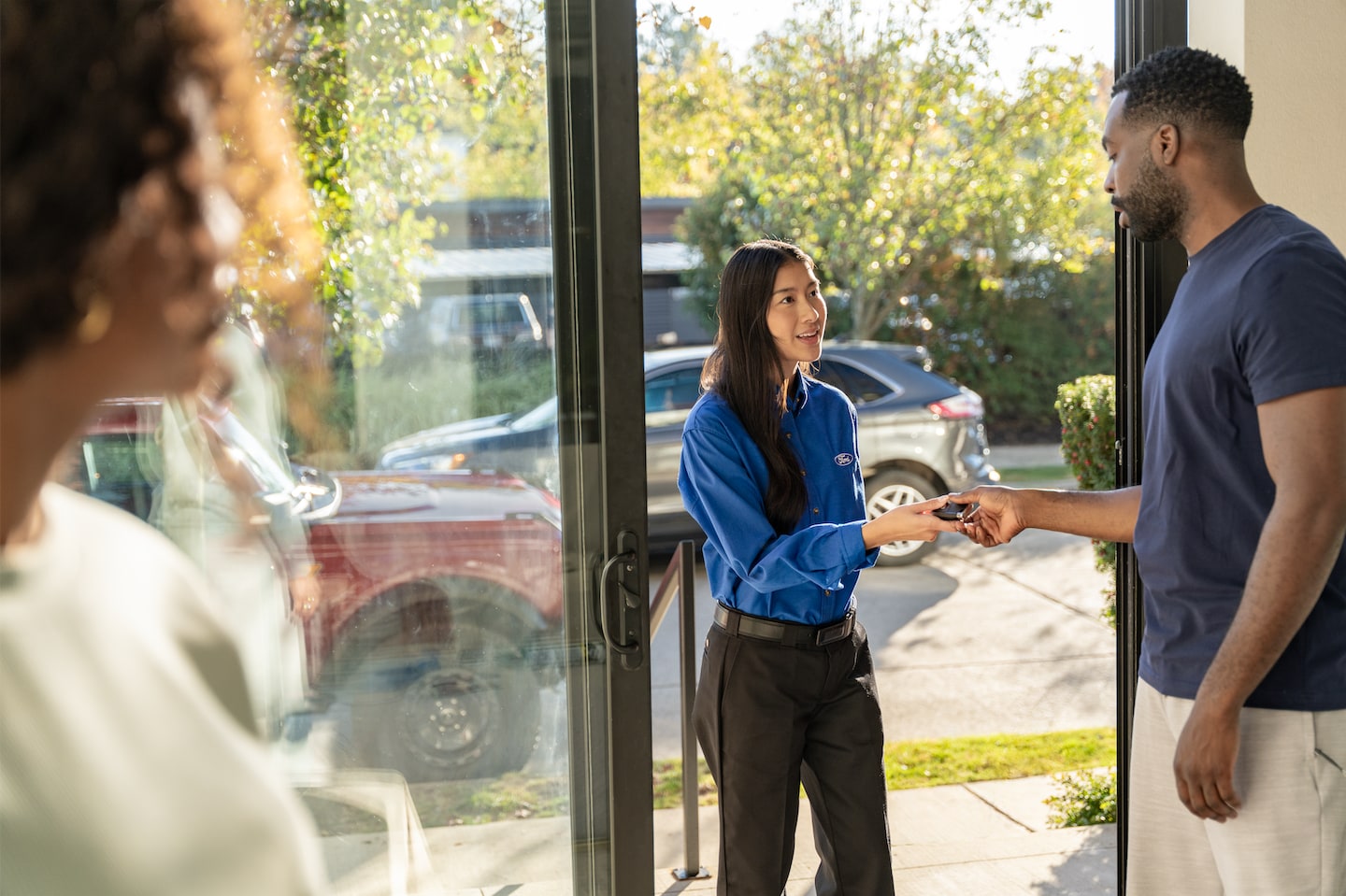 ford service delivery woman handing keys to customer