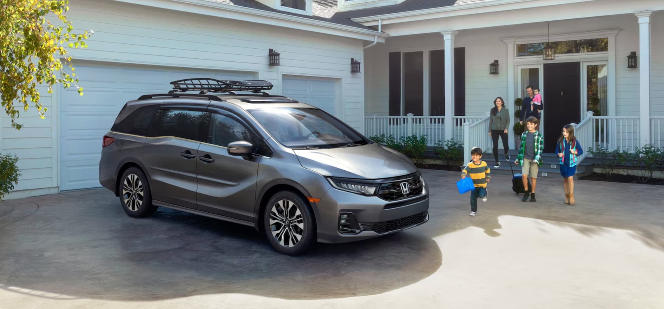 Family approaching a 2026 Honda Odyssey from Fox Honda near Kentwood