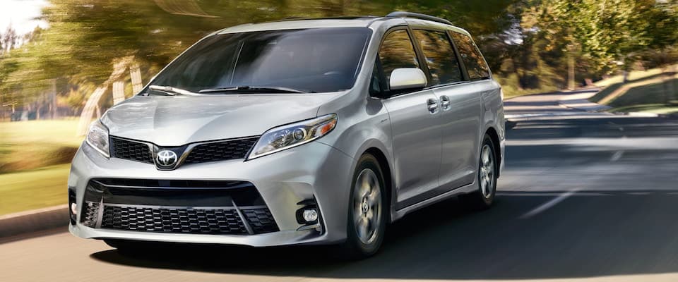 A silver 2019 Toyota Sienna driving down an open road