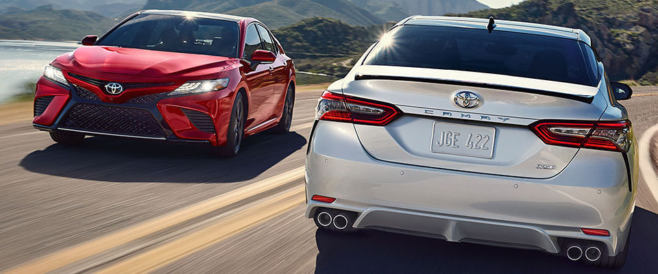 2019 Toyota Camry A white &red 2019 Toyota Camry passing each other on a highway