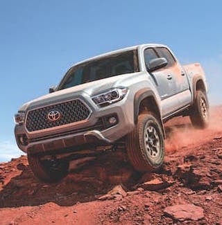 A silver 2019 Toyota Tacoma offroading