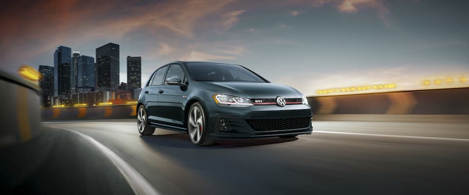 2019 Volkswagen Gold GTI A black 2019 VW Golf GTI driving out of the city