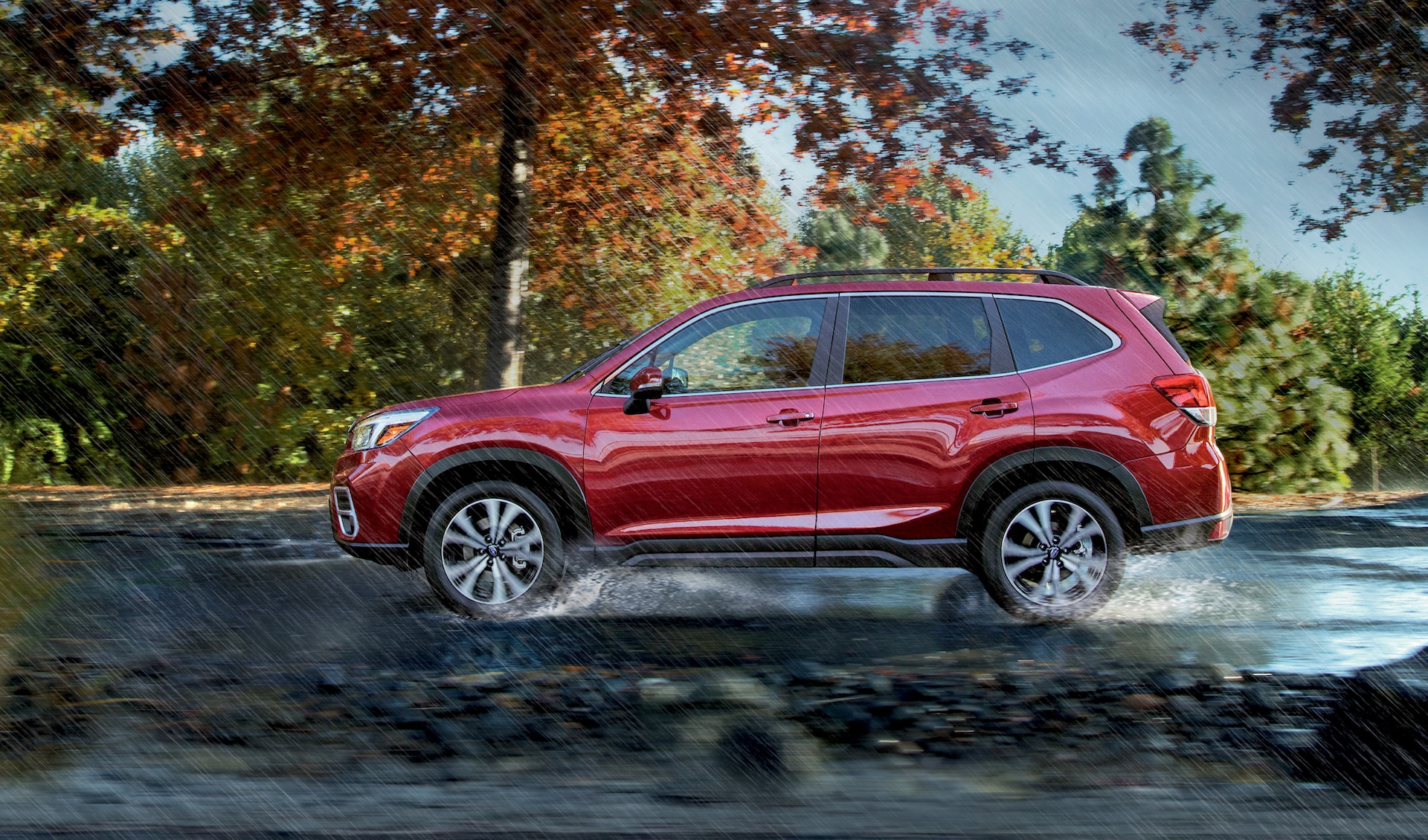 Fletcher Subaru is a Subaru Dealership in Joplin near Joplin, MO | 2020 Subaru Forester driving through puddle