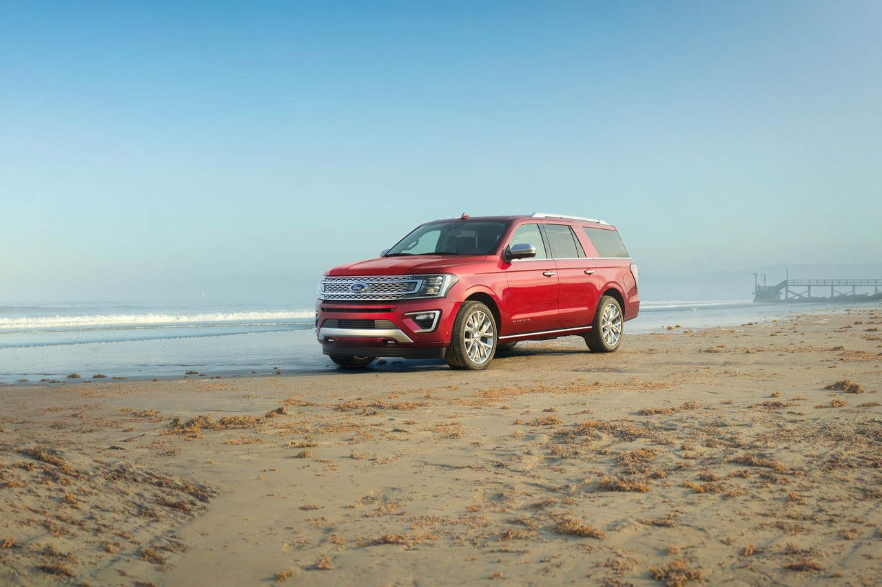 New Burgundy Ford Expedition SUV Parked On a Sandy Beach