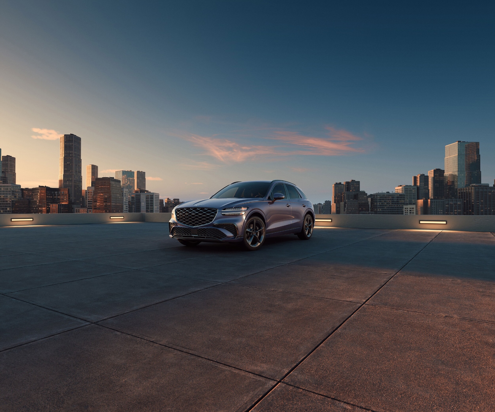 Genesis GV70 parked with cityscape in background