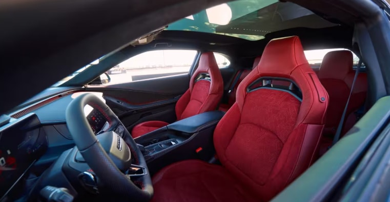 2026 Dodge Charger interior with red sport seats and a driver-focused cockpit.