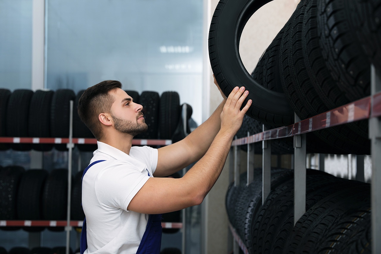 Service technician picking out new Genesis tires