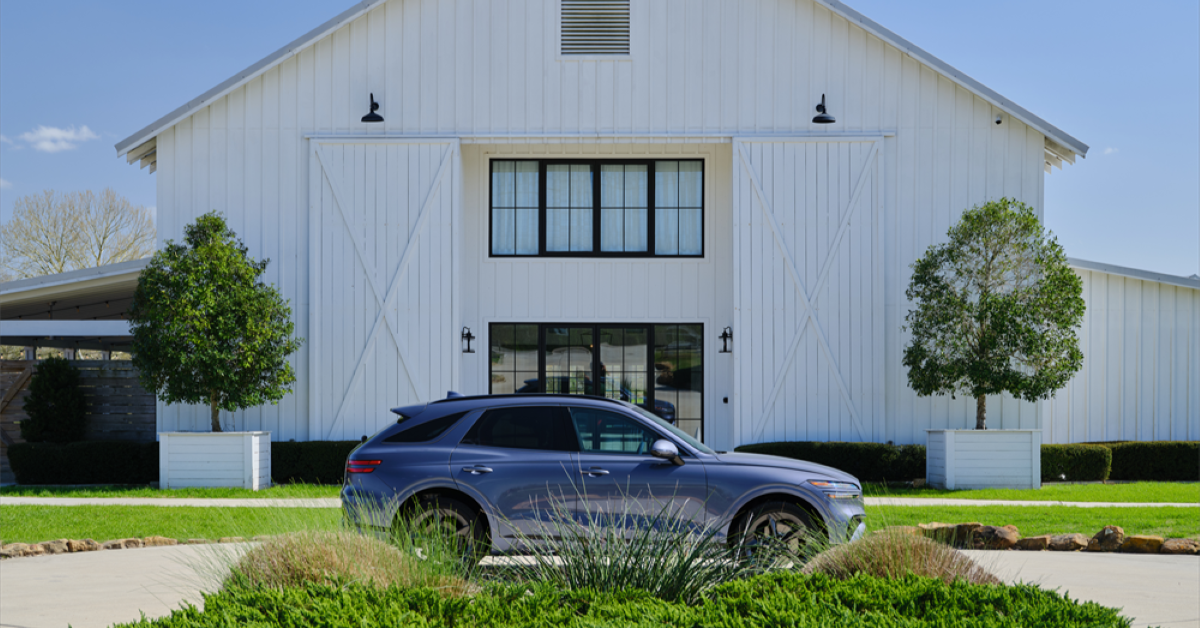 2026 Genesis GV70 parked outside of white barn.