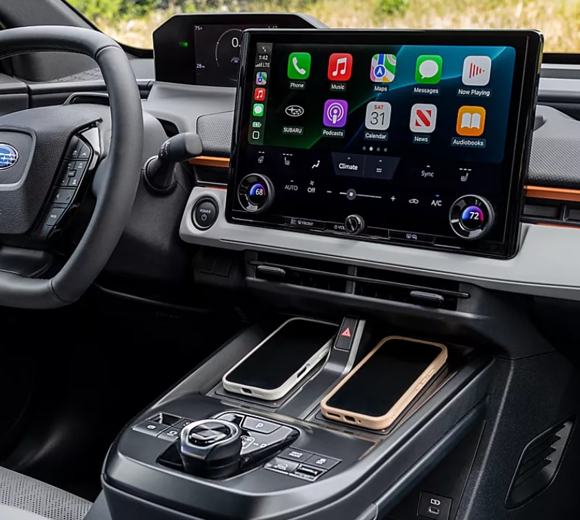 Screenshot%202025-09-22%20182728.png 2026 Subaru Uncharted EV interior with large touchscreen infotainment system and smartphone integration.