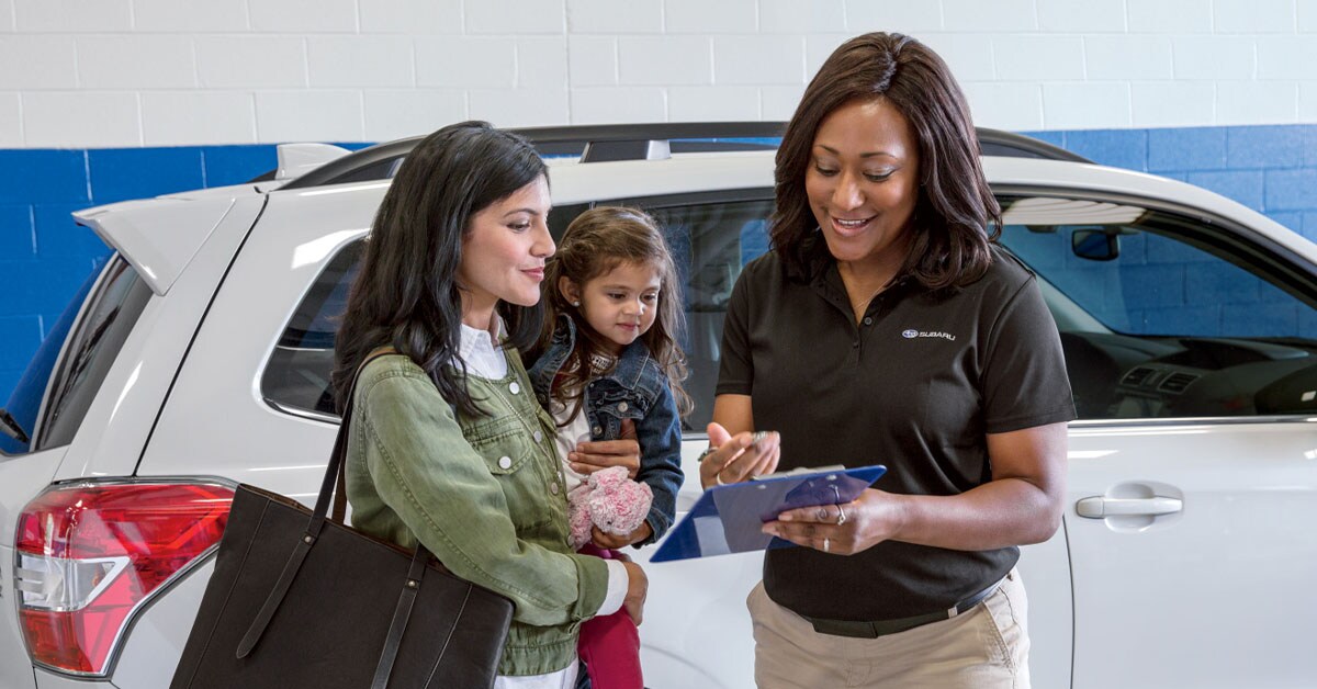 Mother and daughter speaking to Subaru sales representative.