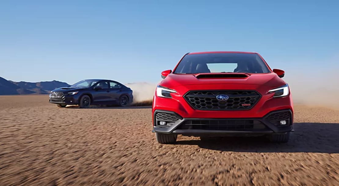Two 2026 Subaru WRX vehicles driving in the dessert