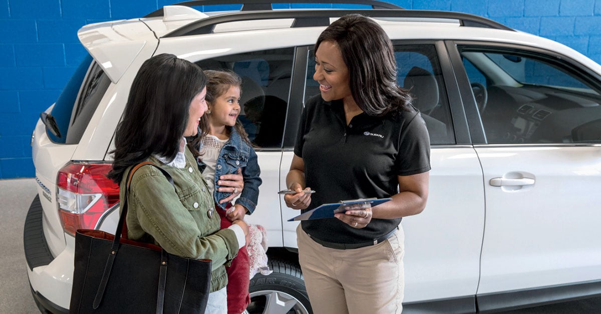 Customer speaking to salesperson at a Subaru dealership