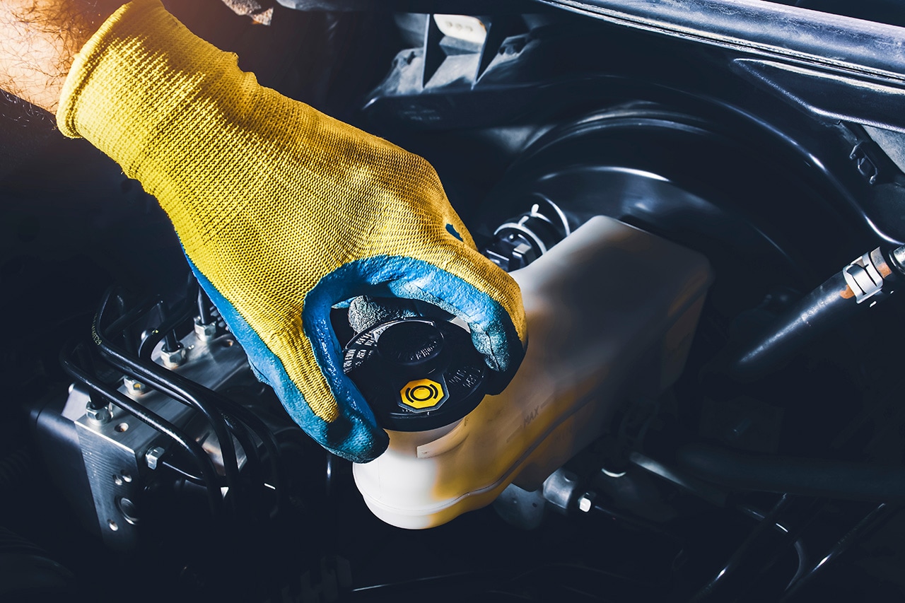 Subaru service technician working on a brake system