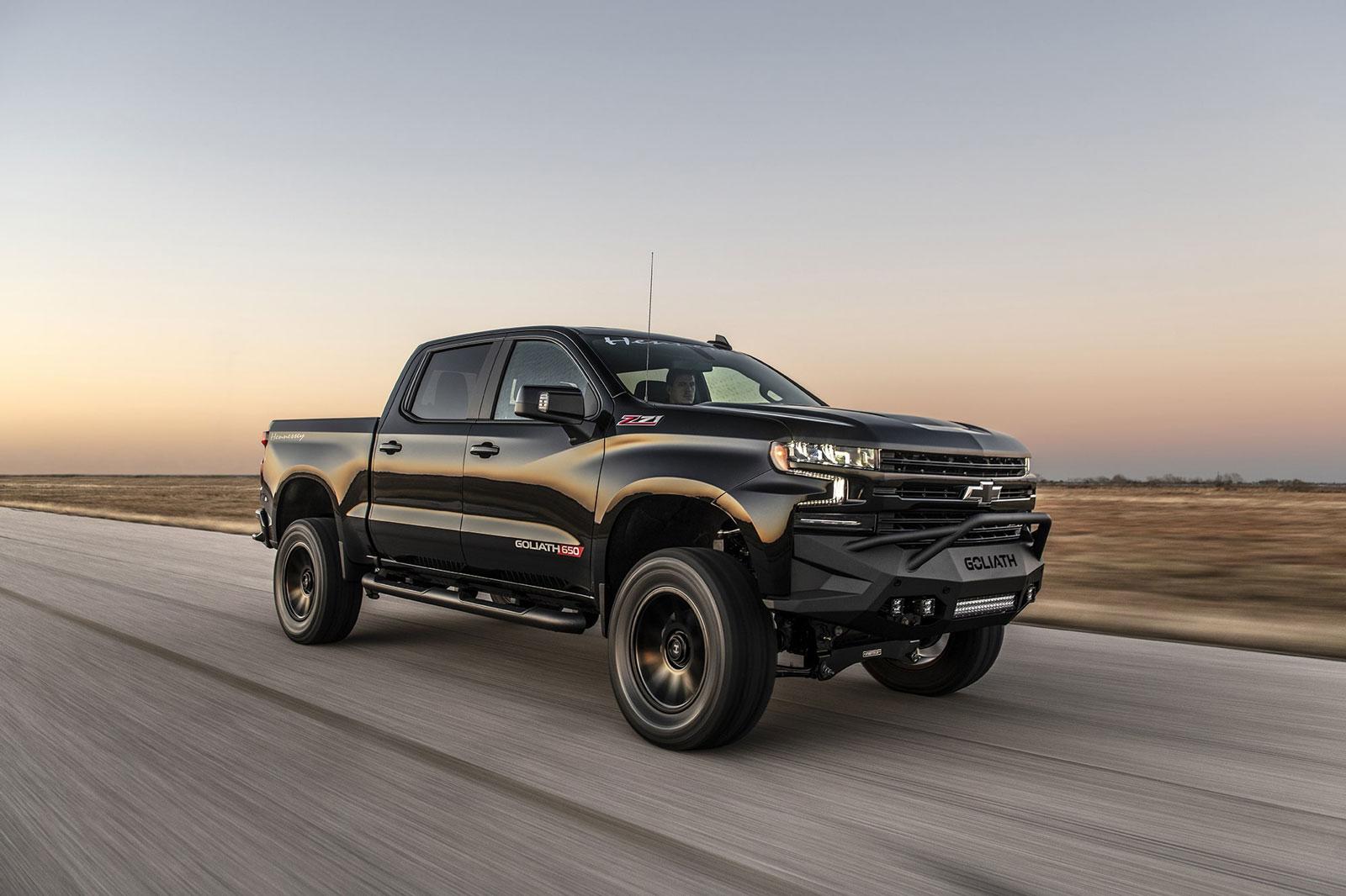 Shiny black Chevy Silverado with Hennessey Goliath  650 Supercharged upgrades, from front right