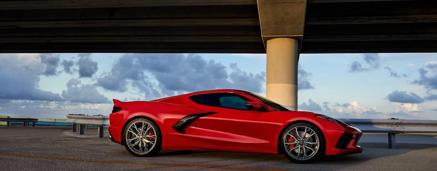 A red 2024 Chevy Corvette Stingray is shown from the side.
