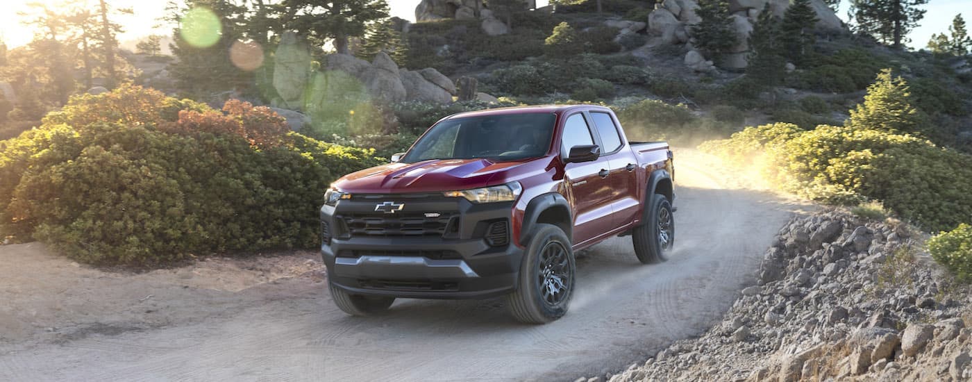 A red 2024 Chevy Colorado Trail Boss is shown from the front at an angle after leaving a Chevy dealer near Vineyard.