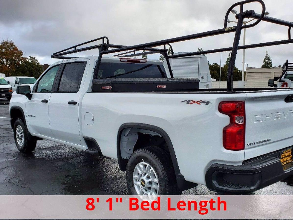 Rear view of a white Chevy Silverado 2500HD crew cab with 8 foot long bed, Rack It rack, and toolbox
