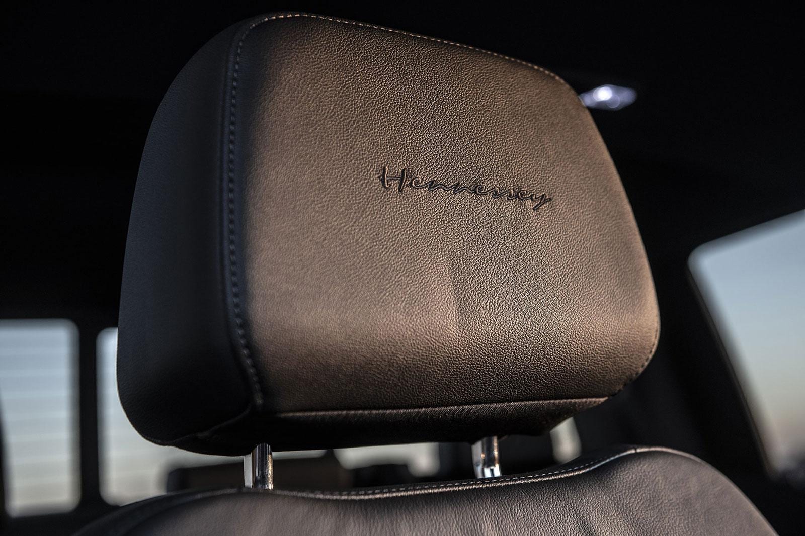Detail of Hennessey embroidered headrest in a black Chevy Silverado