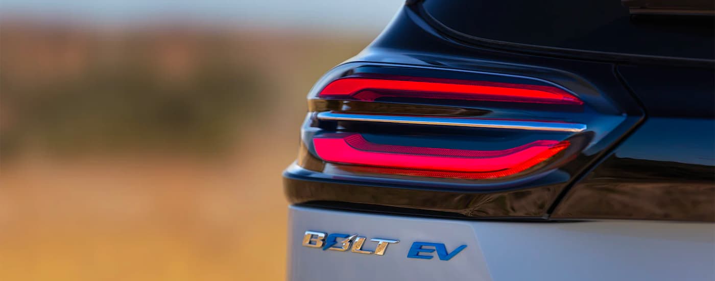 A close up of the drivers side taillight and badging on a silver 2022 Chevy Bolt EV at a Citrus Heights Chevy Dealer.