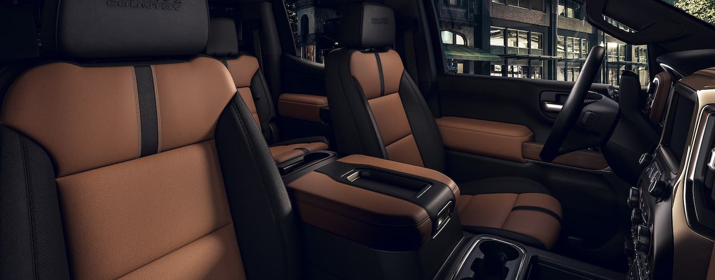 The black and brown interior and front seats are shown in 2022 Chevy Silverado 1500 High Country.