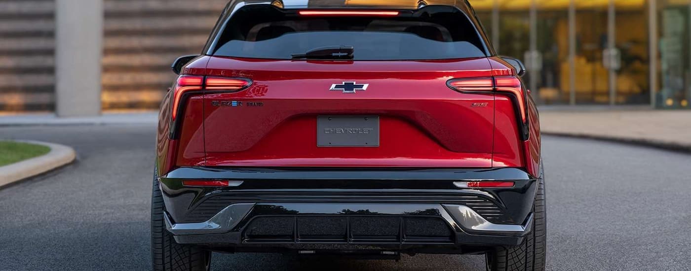 A red 2024 Chevy Blazer EV SS is shown from the rear while parked on the side of street.