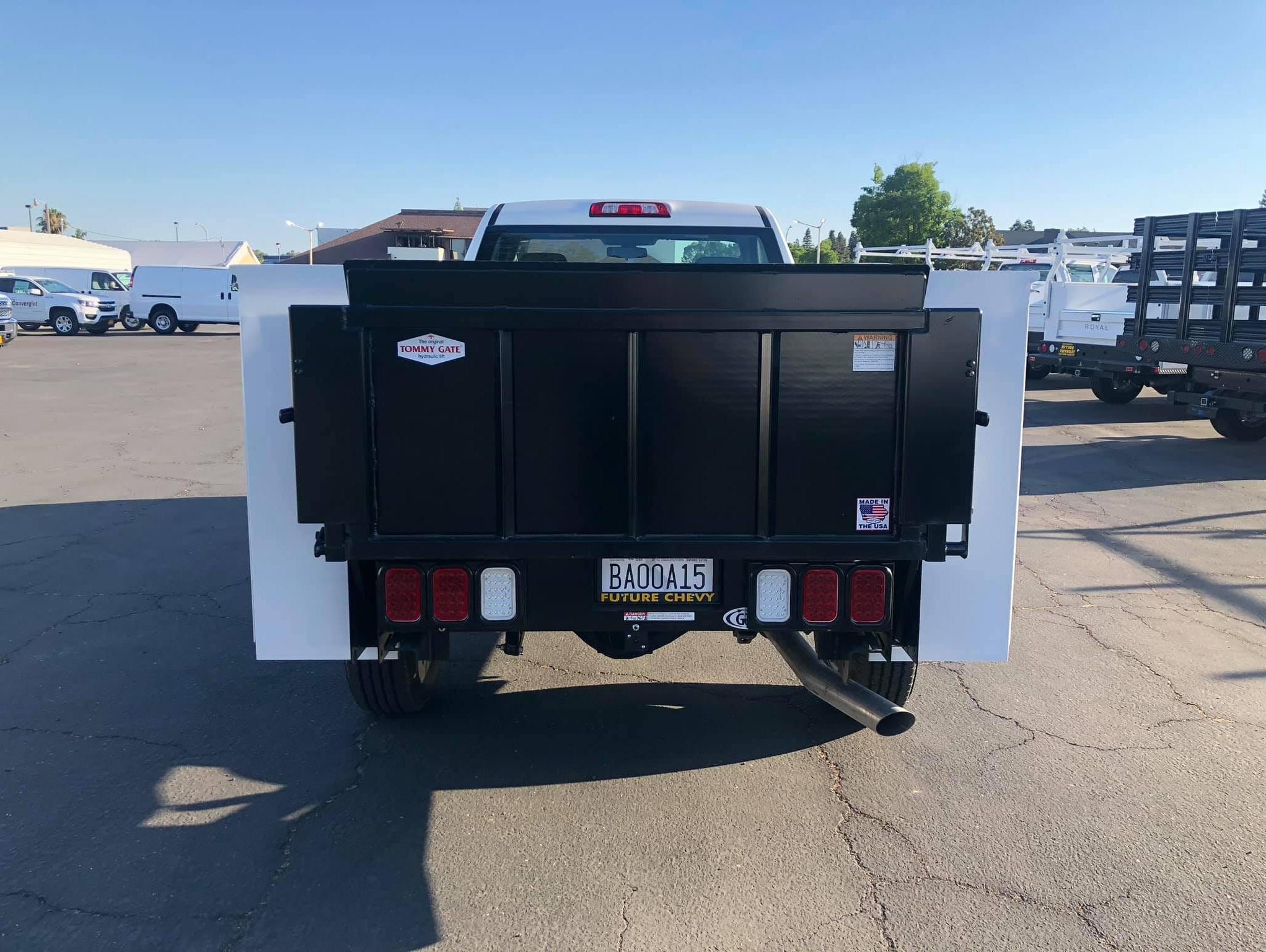 Rear view of a white Chevy Silverado 2500HD regular cab with Knapheide body and Tommy liftgate