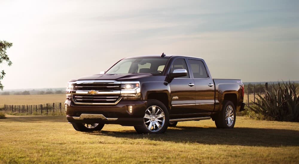 A black 2017 Chevy Silverado 1500 High Country parked in a field
