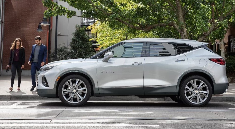 A silver 2022 Chevy Blazer is shown from the side on a city street.