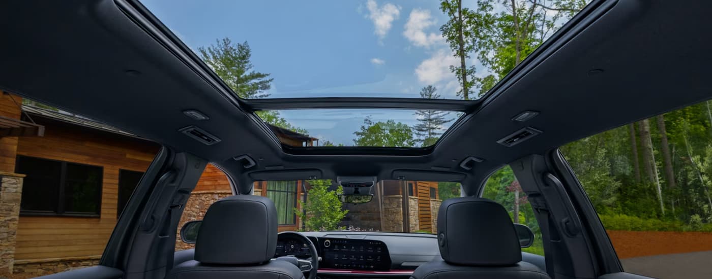 The black interior of a 2024 Chevy Traverse shows the sunroof and back of the front seats.