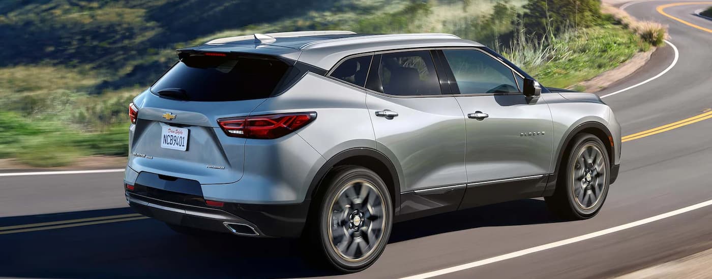 Chevy Blazer for sale - 2023 Chevy Blazer Premier - Silver Corner.jpg A silver 2023 Chevy Blazer Premier driving on a winding road through the countryside.