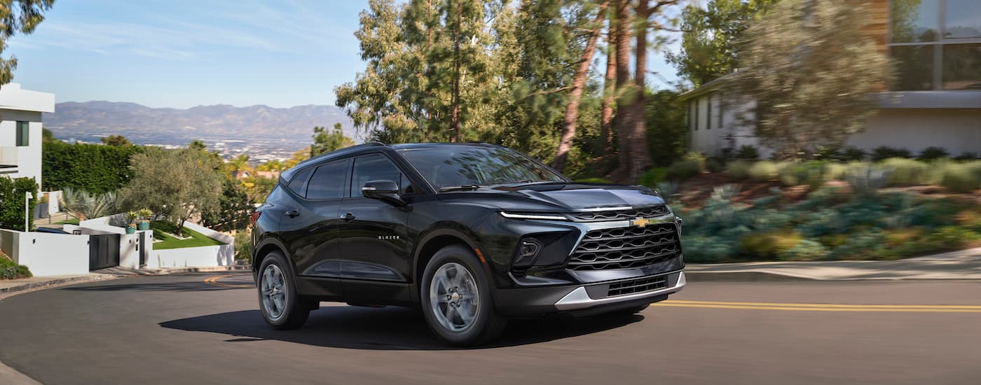 A black 2024 Chevy Blazer is shown from the front at an angle.