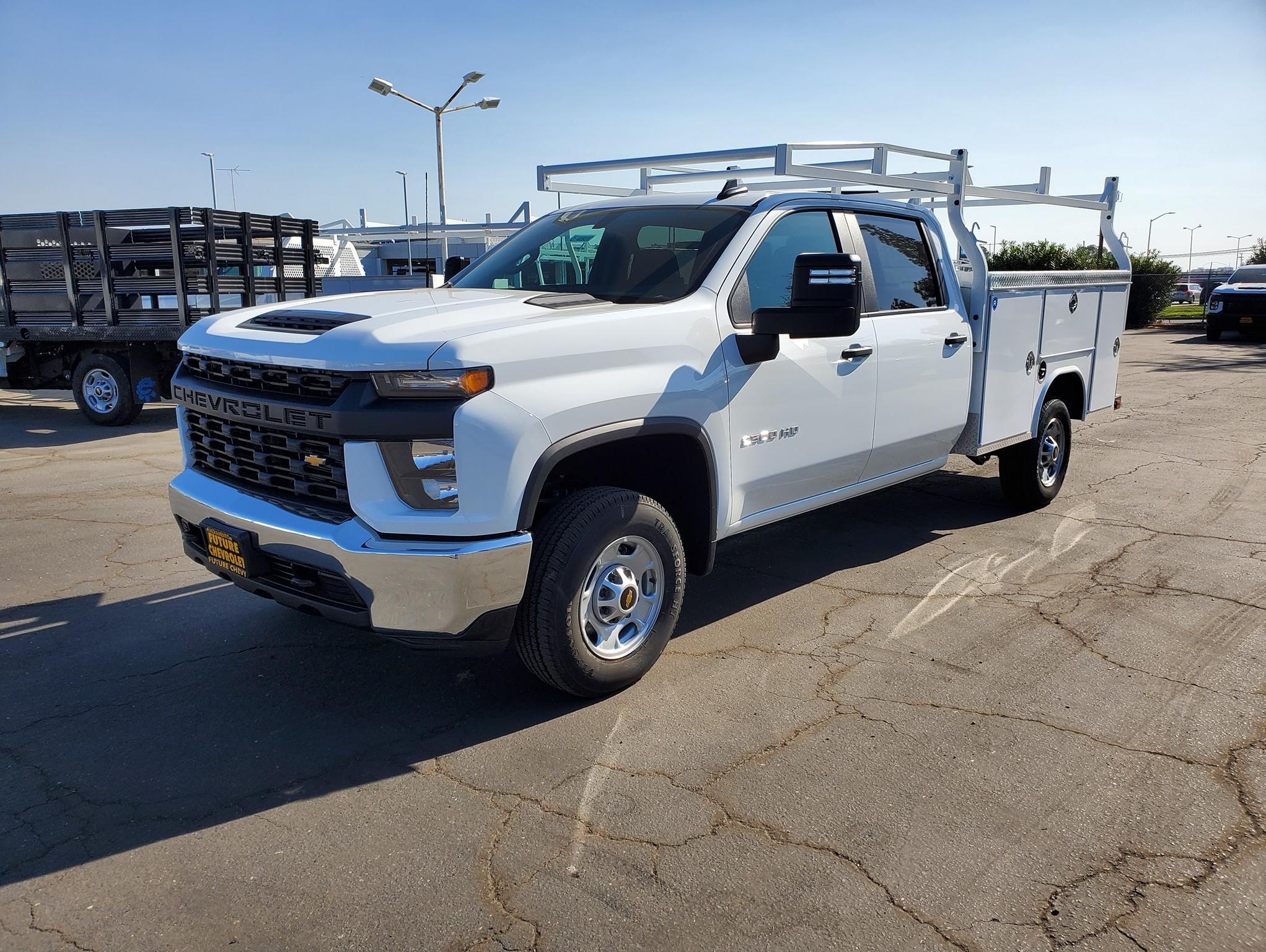 Front view of a white Chevy Silverado 2500HD crew cab with Royal service body