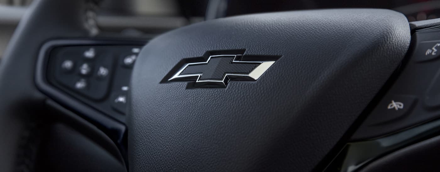 A close up shows the steering wheel and chevy logo in a 2022 Chevy Equinox RS.